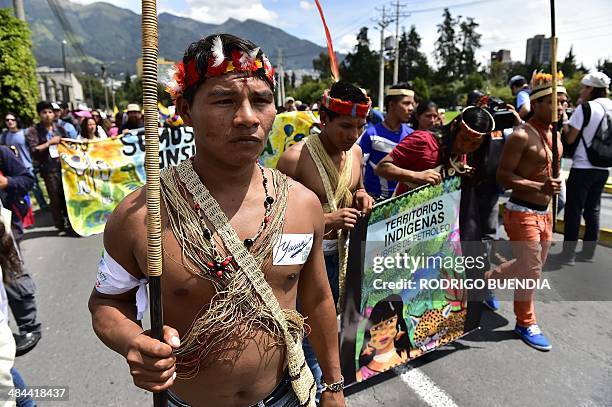 Huaorani natives and Yasunidos ecologist group activists march in Quito on April 12, 2014 toward the National Electoral Council to leave the...