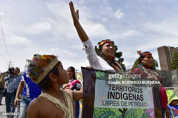 Huaorani natives and Yasunidos ecologist group activists march in Quito on April 12, 2014 toward the National Electoral Council to leave the...