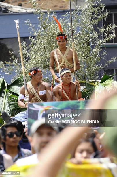 Huaorani natives and Yasunidos ecologist group activists march in Quito on April 12, 2014 toward the National Electoral Council to leave the...