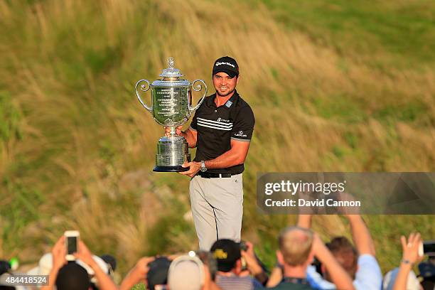 Jason Day of Australia proudly holds the Wanamaker Trophy after his victory with a record Major score of 20 under par during the final round of the...