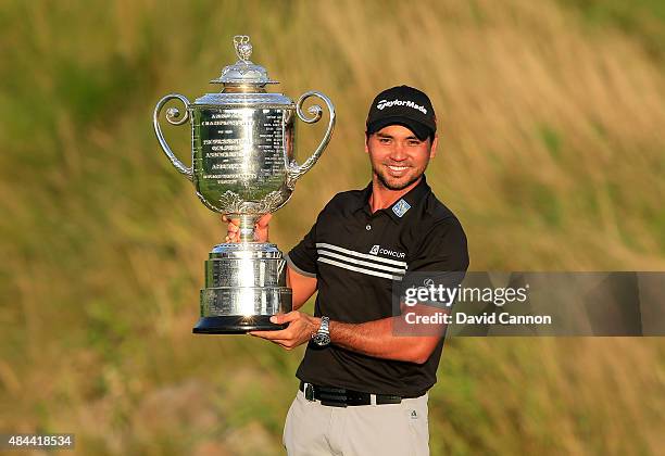 Jason Day of Australia proudly holds the Wanamaker Trophy after his victory with a record Major score of 20 under par during the final round of the...