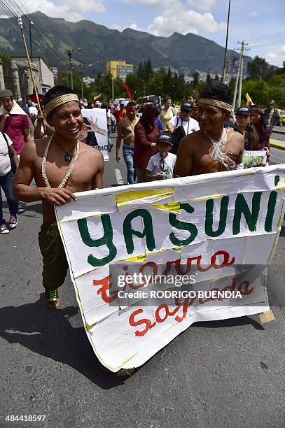 Huaorani natives and Yasunidos ecologist group activists march in Quito on April 12, 2014 toward the National Electoral Council to leave the...