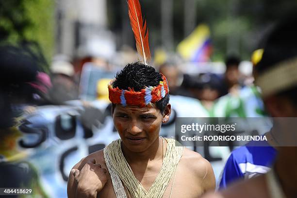 Huaorani natives and Yasunidos ecologist group activists march in Quito on April 12, 2014 toward the National Electoral Council to leave the...