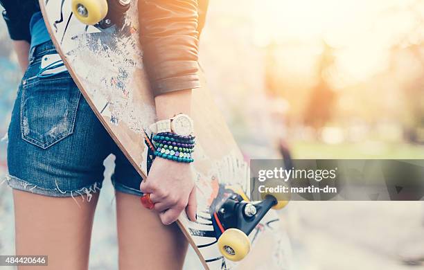 close up of a teenage girl holding skateboard - pocket stock pictures, royalty-free photos & images