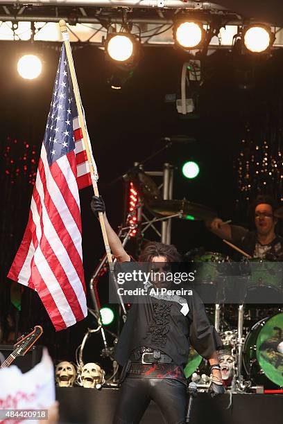 Alice Cooper waves an American Flag when he performs during "FOX & Friends" All American Concert Series outside of FOX Studios on August 14, 2015 in...