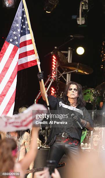 Alice Cooper waves an American Flag when he performs during "FOX & Friends" All American Concert Series outside of FOX Studios on August 14, 2015 in...