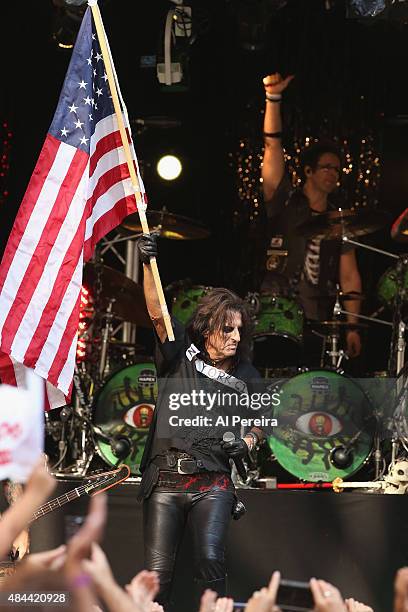 Alice Cooper waves an American Flag when he performs during "FOX & Friends" All American Concert Series outside of FOX Studios on August 14, 2015 in...