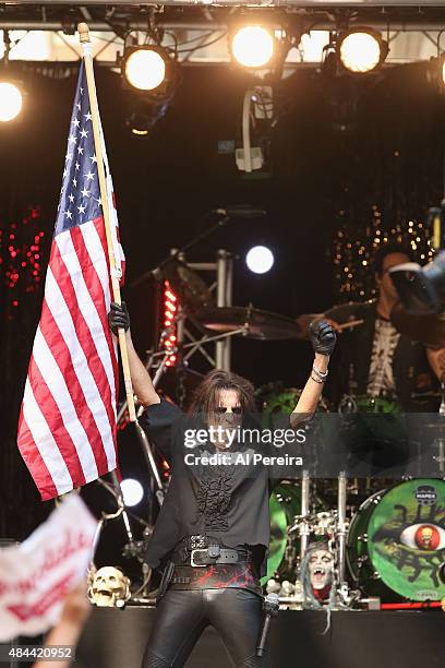 Alice Cooper waves an American Flag when he performs during "FOX & Friends" All American Concert Series outside of FOX Studios on August 14, 2015 in...