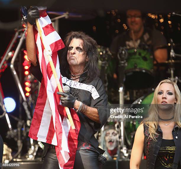 Alice Cooper waves an American Flag when he performs during "FOX & Friends" All American Concert Series outside of FOX Studios on August 14, 2015 in...