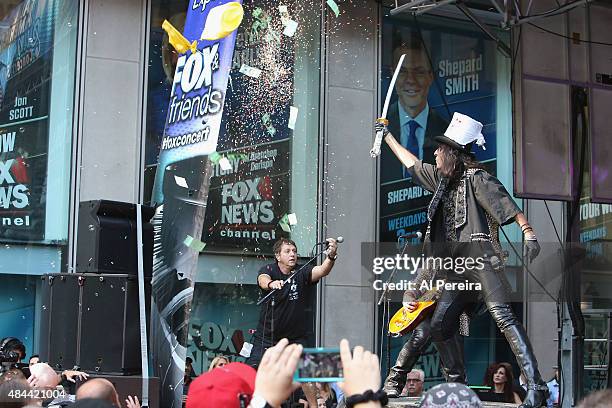 Alice Cooper pops confetti-filled balloons with a sword when he performs during "FOX & Friends" All American Concert Series outside of FOX Studios on...