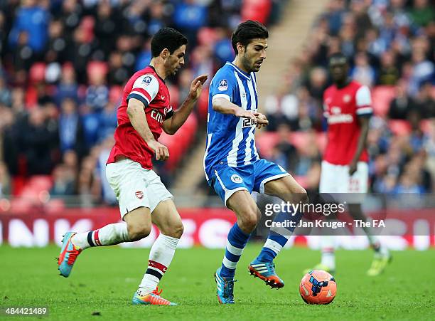 Jordi Gomez of Wigan Athletic holds off Mikel Arteta of Arsenal during the FA Cup Semi-Final match between Wigan Athletic and Arsenal at Wembley...