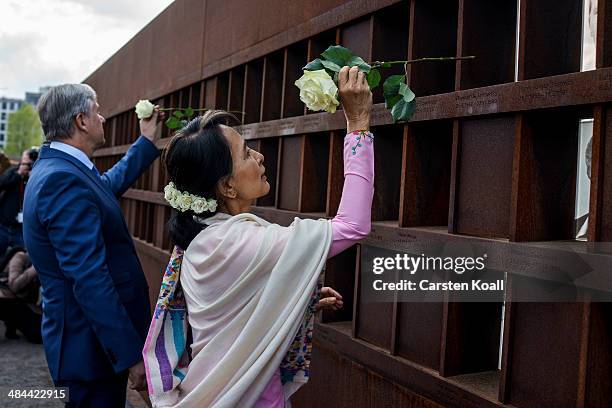 Myanmar pro-democracy leader Aung San Suu Kyi and Berlin's Major Klaus Wowereit place flowers on a memorial for victims of the Berlin wall during a...