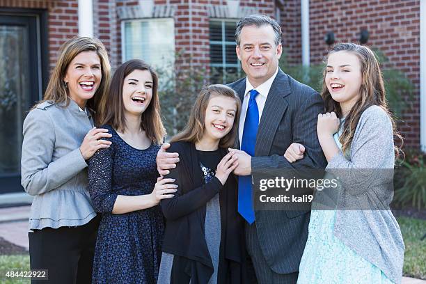 well-dressed family with three children outside home - sunday best stock pictures, royalty-free photos & images