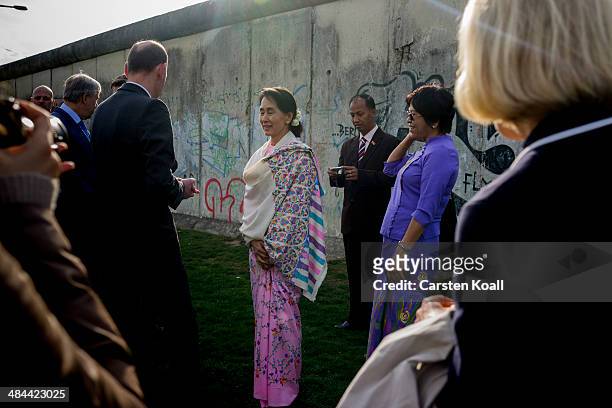 Myanmar pro-democracy leader Aung San Suu Kyi stays in front of the wall backside during a visit to the Berlin Wall Memorial on April 12, 2014 in...