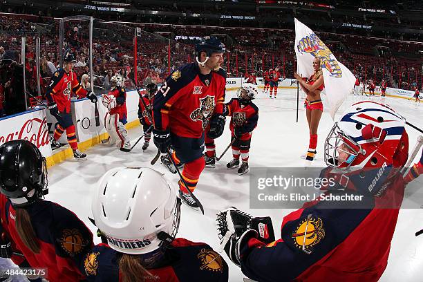 Junior skaters greet Krys Barch of the Florida Panthers prior to the start of the game against the Dallas Stars at the BB&T Center on April 6, 2014...