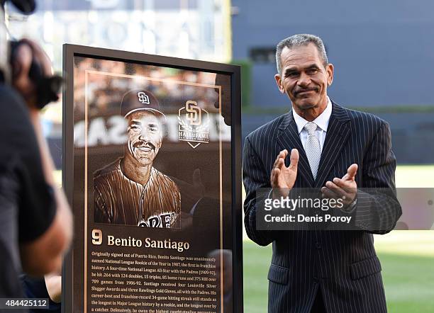 Former San Diego Padres catcher Benito Santiago stands next to his plaque as he's inducted into the San Diego Padres Hall of Fame before a baseball...