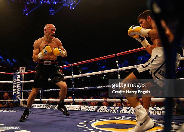 Sergey Khomitsky knocks back Frank Buglioni to win their WBO European Super-Middleweight Championship bout at The Copper Box on April 12, 2014 in...