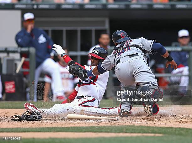 Alexei Ramirez of the Chicago White Sox avoids the tag by Carlos Santana of the Cleveland Indians to score a run in the 5th inning at U.S. Cellular...