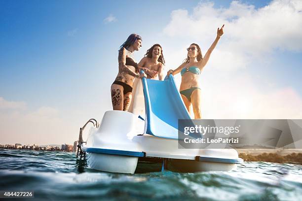 best friend enjoying summer and pedalo fun - pedal boat stock pictures, royalty-free photos & images