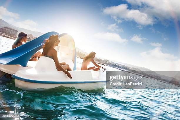 best friend enjoying summer and pedalo fun - paddleboat stock pictures, royalty-free photos & images