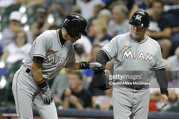 Ichiro Suzuki of the Miami Marlins stands at first base after hitting a single in the third inning against the Milwaukee Brewers at Miller Park on...