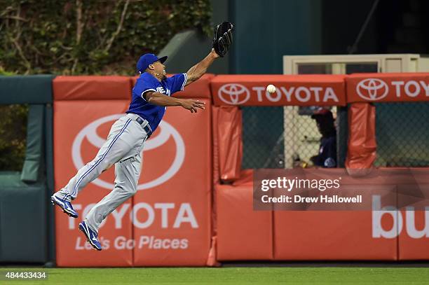 Ben Revere of the Toronto Blue Jays is unable to make a catch in the sixth inning against the Philadelphia Phillies at Citizens Bank Park on August...