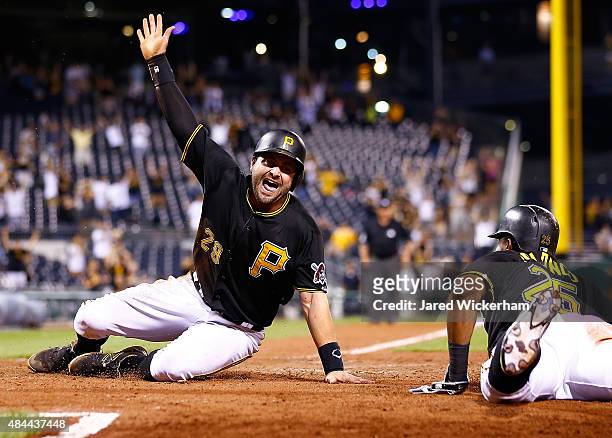 Francisco Cervelli of the Pittsburgh Pirates slides safely into home plate to score the game winning run in the 15th inning against the Arizona...