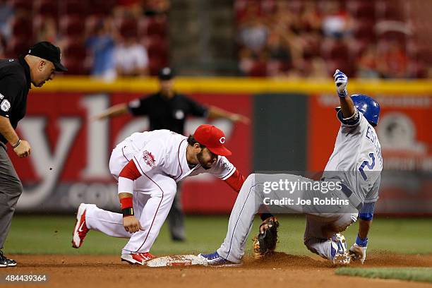 Alcides Escobar of the Kansas City Royals is tagged out trying to reach second base by Eugenio Suarez of the Cincinnati Reds in the 11th inning at...