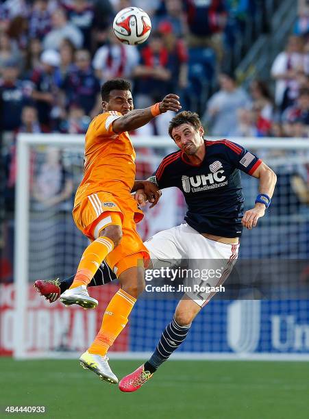 Giles Barnes of the Houston Dynamo battles Andy Dorman of the New England Revolution in the 1st half at Gillette Stadium on April 12, 2014 in...