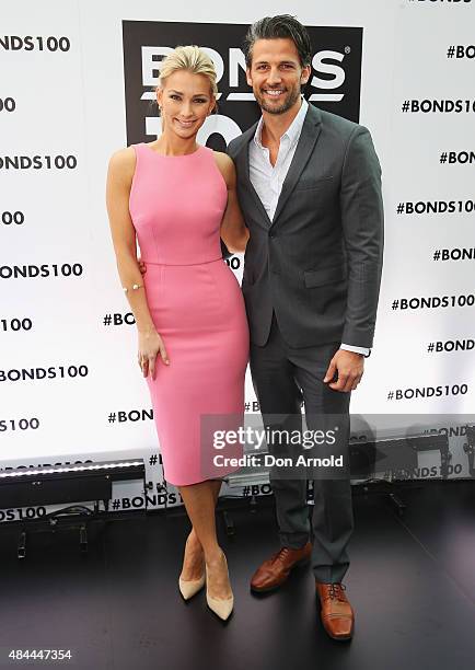 Anna Heinrich and Tim Robards pose during Bonds 100th birthday celebration event at Cafe Sydney on August 19, 2015 in Sydney, Australia.