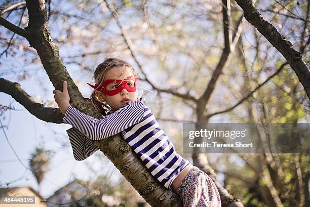 girl climbing tree and wearing mask - short trees bildbanksfoton och bilder