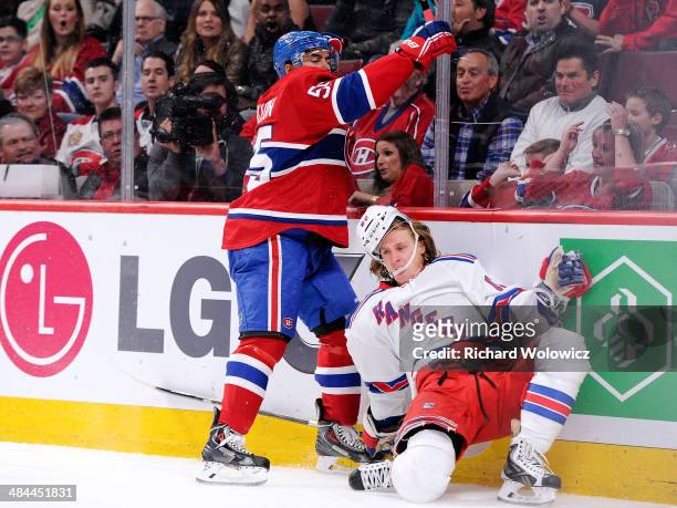 Francis Bouillon of the Montreal Canadiens body checks Carl Hagelin of the New York Rangers during the NHL game at the Bell Centre on April 12, 2014...