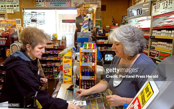 Staff photo by Doug Jones -- Thursday, January 31, 2008: Pat MacDonald, left, buys lottery tickets for herself and friends from Christine Martin at...