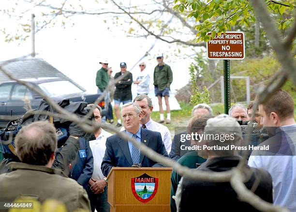 John Patriquin/Staff Photographer; -- Monday, May 21, 2007. A small group watches from private property as state and local officials led by Roland...