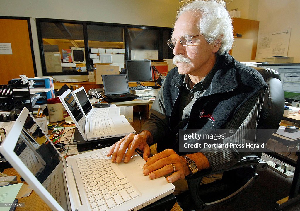 Jeff Hathaway, computer lab technician at Brunswick High School, works on new laptop computers purch
