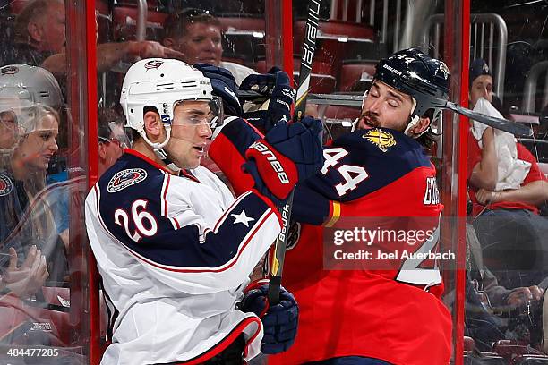 Corey Tropp of the Columbus Blue Jackets and Erik Gudbranson of the Florida Panthers come together behind the net during second period action at the...