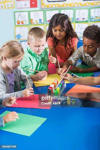 multi-ethnic children in kindergarten doing art project - preschool art stock pictures, royalty-free photos & images