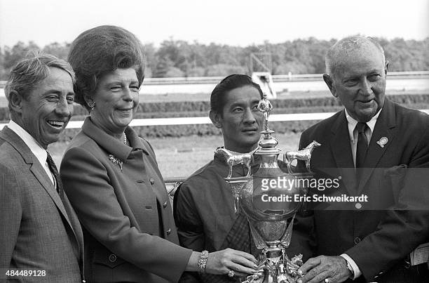 United Nations Stakes: Portrait of trainer John Nerud victorious with Dr. Fager jockey Braulio Baeza and owners James Binger and Virginia McKnight...