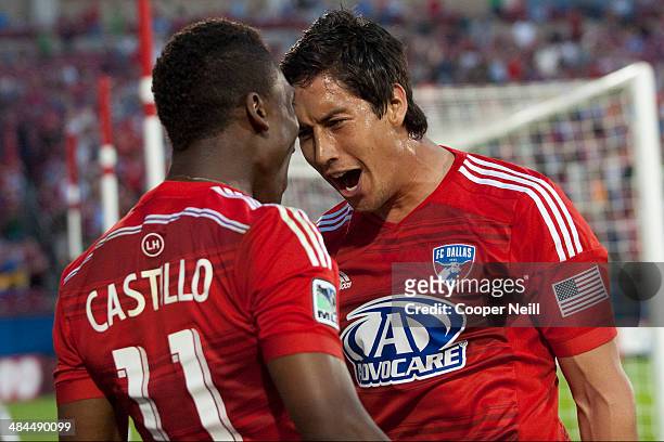 David Texeira of the FC Dallas celebrates with teammate Fabian Castillo after scoring a goal against the Seattle Sounders FC on April 12, 2014 at...
