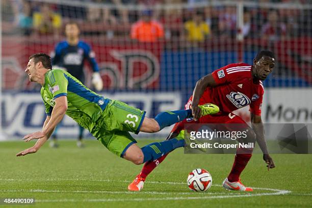 Kenny Cooper of the Seattle Sounders FC has the ball stolen by Hendry Thomas of the FC Dallas on April 12, 2014 at Toyota Stadium in Frisco, Texas.