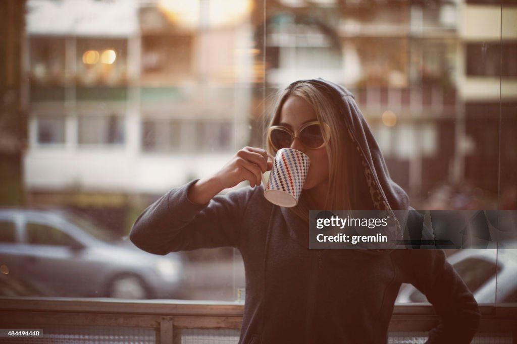 Young woman drinking late morning coffee