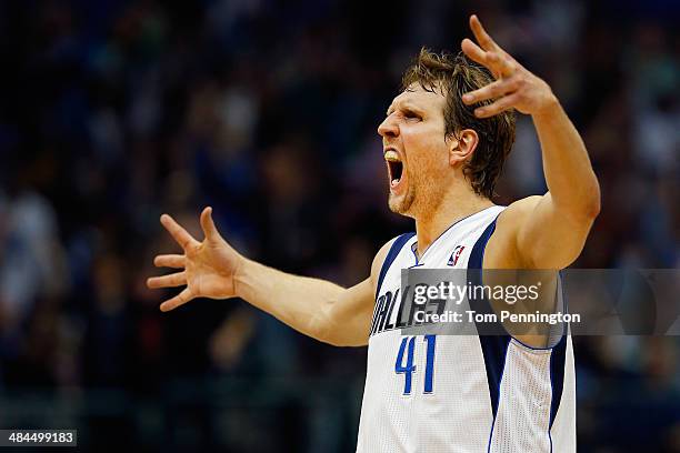 Dirk Nowitzki of the Dallas Mavericks reacts after making a three point shot against the Phoenix Suns in the third quarter at American Airlines...