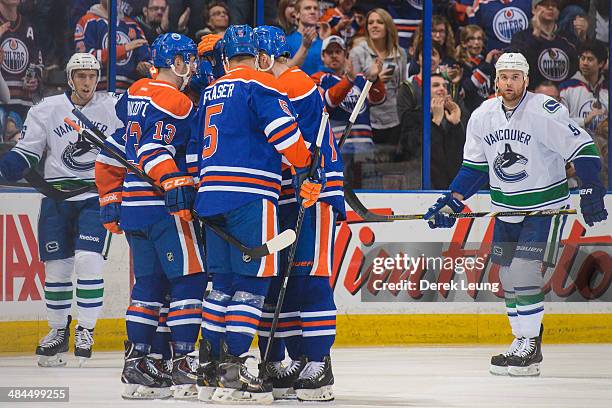 Steve Pinizzotto, Roman Horak, Mark Fraser, and Anton Belov of the Edmonton Oilers celebrate Horak's goal against the Vancouver Canucks during an NHL...