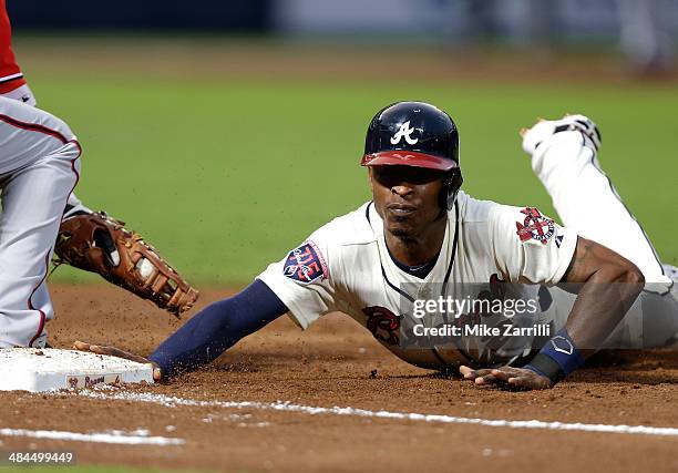 Centerfielder B.J. Upton of the Atlanta Braves slides back into first base on a pickoff attempt during the game against the Washington Nationals at...