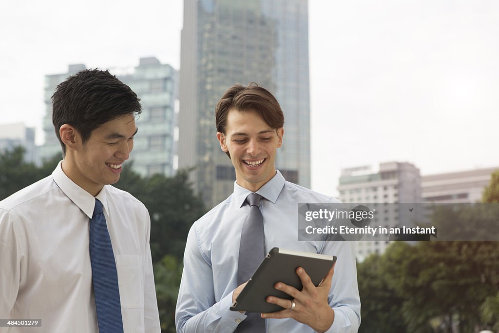 Businessmen working together outdoors.