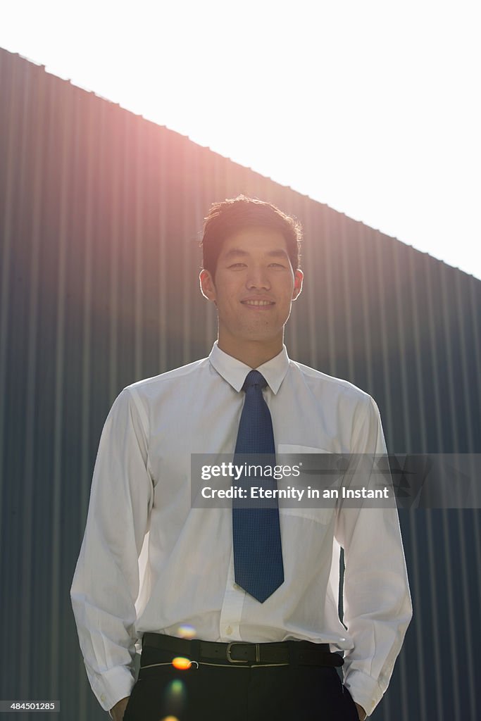 Businessman smiling with sun flare