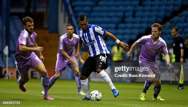 Lewis McGugan of Sheffield is challenged by Orlando Sa and Stephen Quinn of Reading during the Sky Bet Championship match between Sheffield Wednesday...