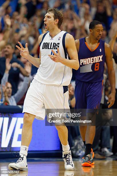 Dirk Nowitzki of the Dallas Mavericks reacts after making a three point shot against the Phoenix Suns at American Airlines Center on April 12, 2014...