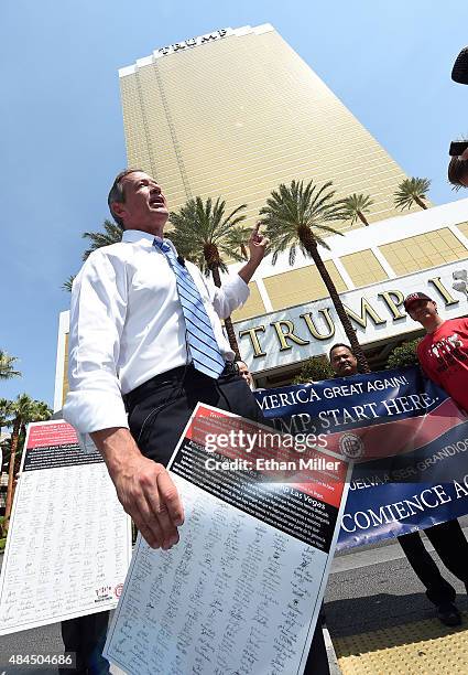 Democratic presidential candidate Martin O'Malley holds a copy of a petition signed by Trump International Hotel & Tower Las Vegas workers asking to...