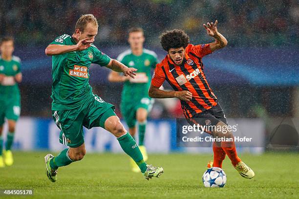 Mario Sonnleitner of Vienna competes for the ball with Taison of Donetsk during the UEFA Champions League: Qualifying Round Play Off First Leg match...